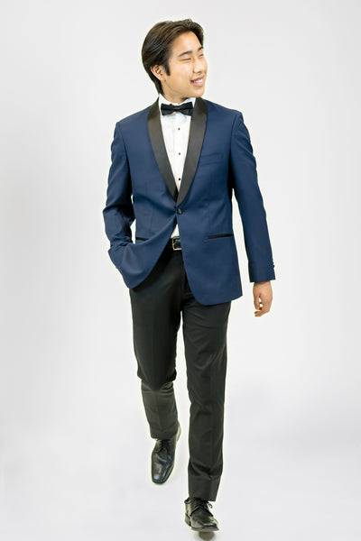 high school student boy wearing navy blue tuxedo black bow tie walking looking right