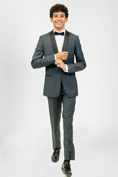 high school student boy wearing charcoal tuxedo black bow tie walking frontward