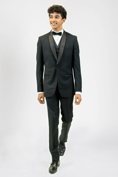 high school student boy wearing black tuxedo bow tie walking frontward looking left