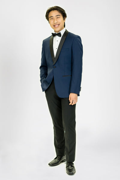 high school student boy wearing navy blue tuxedo black bow tie standing looking frontward