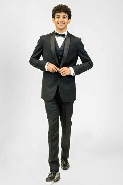 high school student boy wearing black tuxedo bow tie walking looking frontward