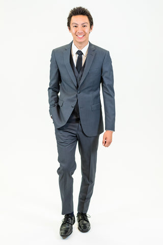 high school student boy wearing charcoal grey suit black tie standing frontward