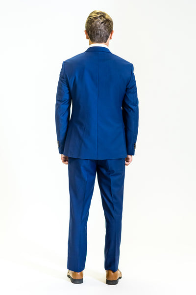 high school student boy wearing cobalt blue suit standing back view