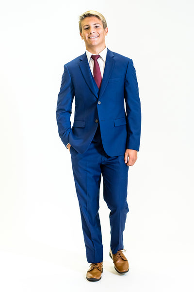 high school student boy wearing cobalt blue suit red tie walking frontward
