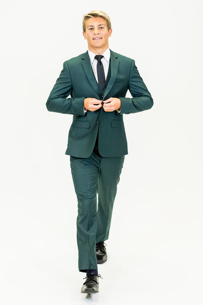 high school student boy wearing green suit black tie walking frontward adjusting buttons