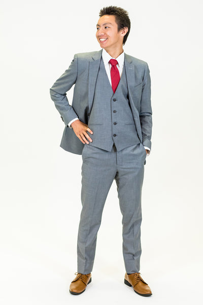 high school student boy wearing grey suit red tie standing frontward facing left