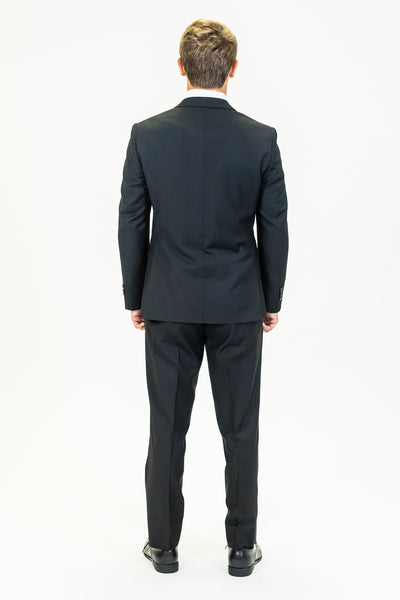 high school student boy wearing black polyester suit standing back view