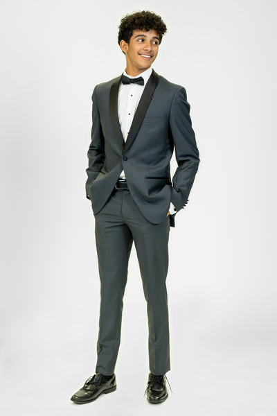 high school student boy wearing charcoal tuxedo black bow tie standing looking right