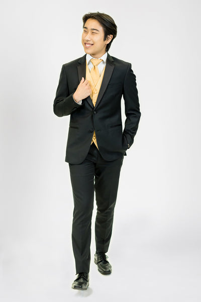 high school student boy wearing black tuxedo gold neck tie walking frontward looking left