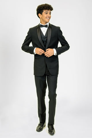 high school student boy wearing black tuxedo bow tie standing looking right