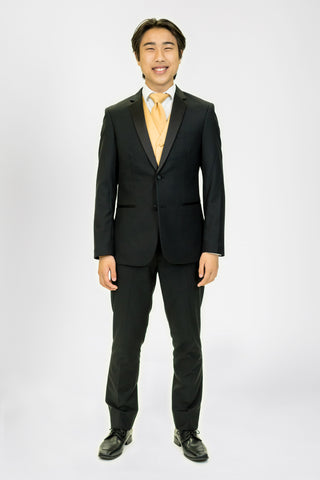 high school student boy wearing black tuxedo gold neck tie standing facing frontward
