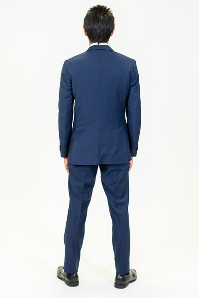 high school student boy wearing navy suit standing back view