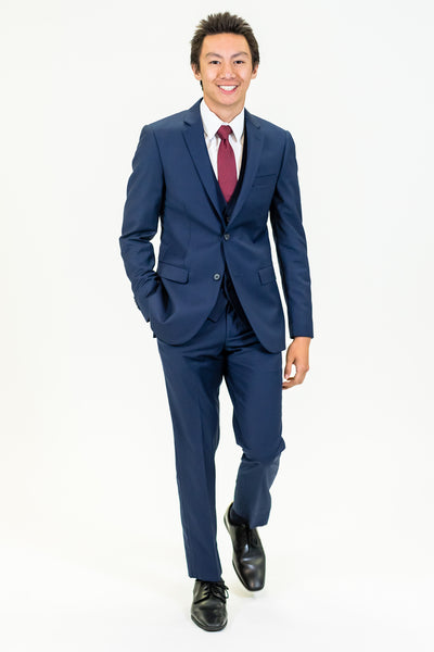 high school student boy wearing navy suit red bow tie walking frontward